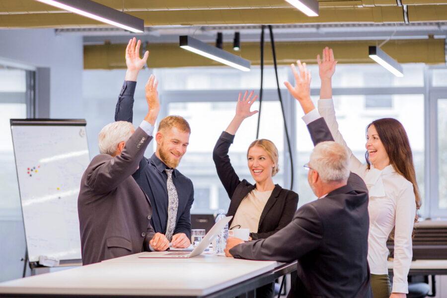 cheerful-business-people-meeting-raising-arms-2-2